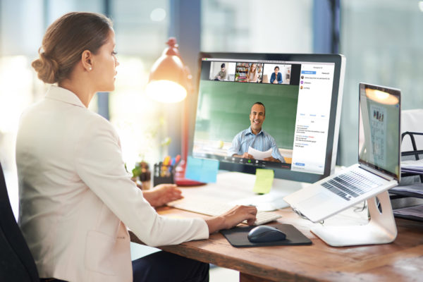 Having a web based one on one Shot of two colleagues video chatting with each other on a computer at work